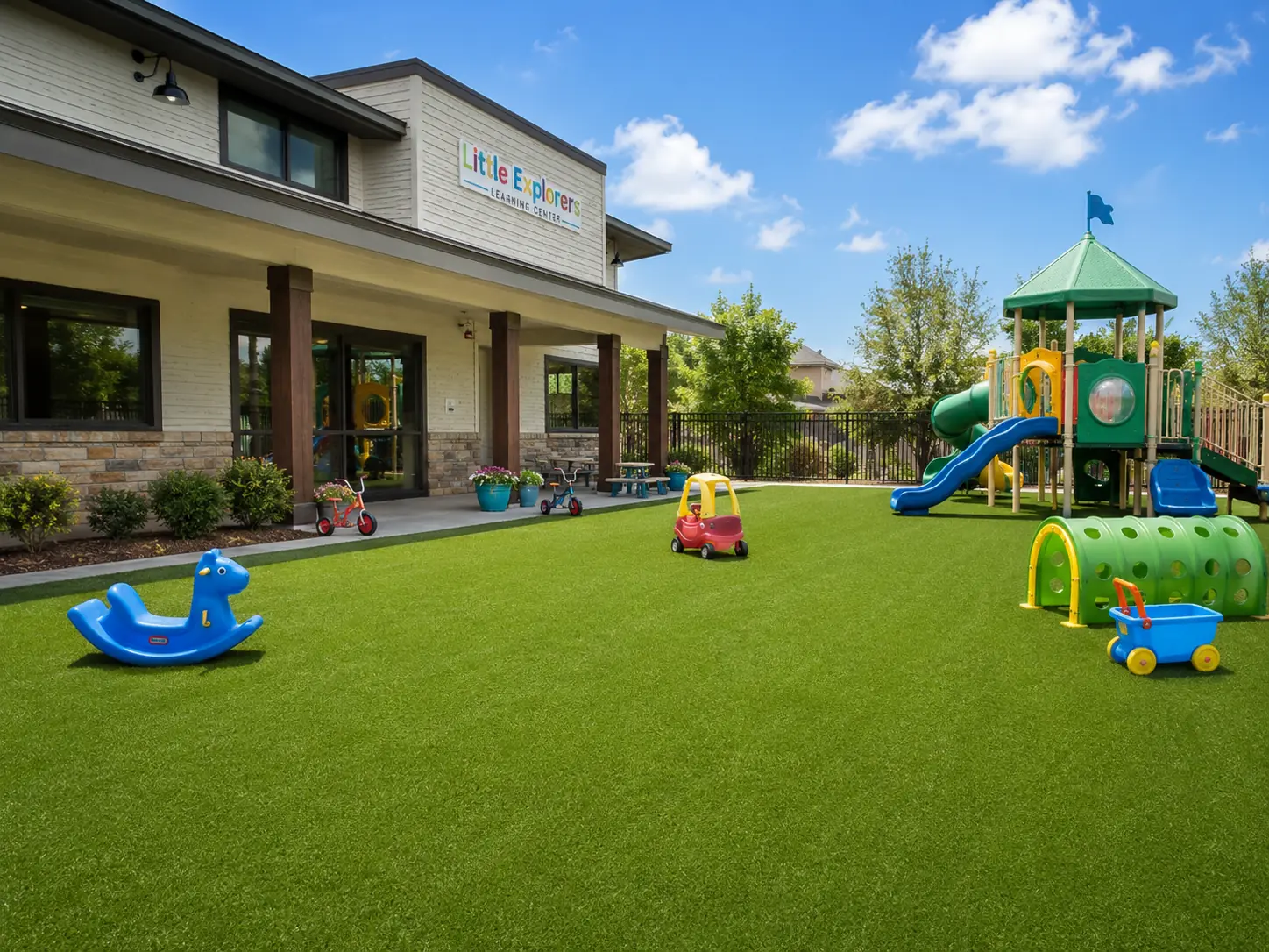 A vibrant green pet turf installation in a modern backyard dog park featuring clean turf lines and happy dogs.