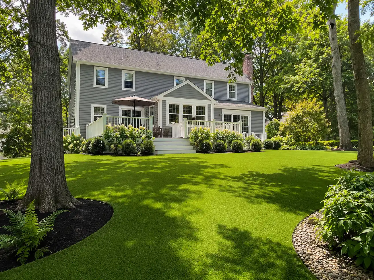 A professionally installed artificial bocce court turf featuring a smooth green playing surface surrounded by crisp borders in a sunny backyard.