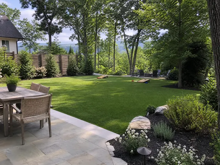A lush green residential backyard featuring multi-use artificial turf installed across an open play and relaxation area.
